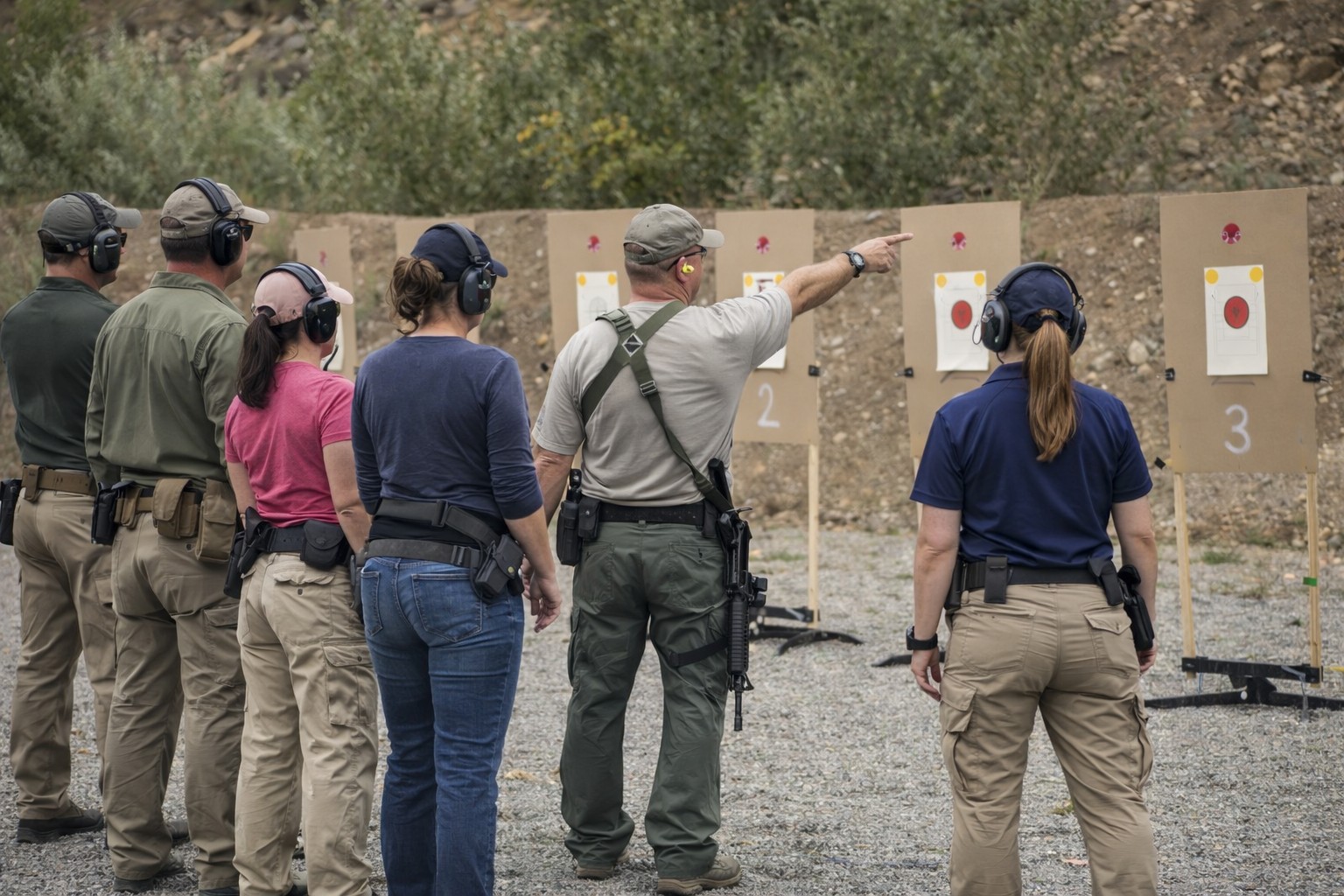Firearms instructors providing private and group training at an outdoor range